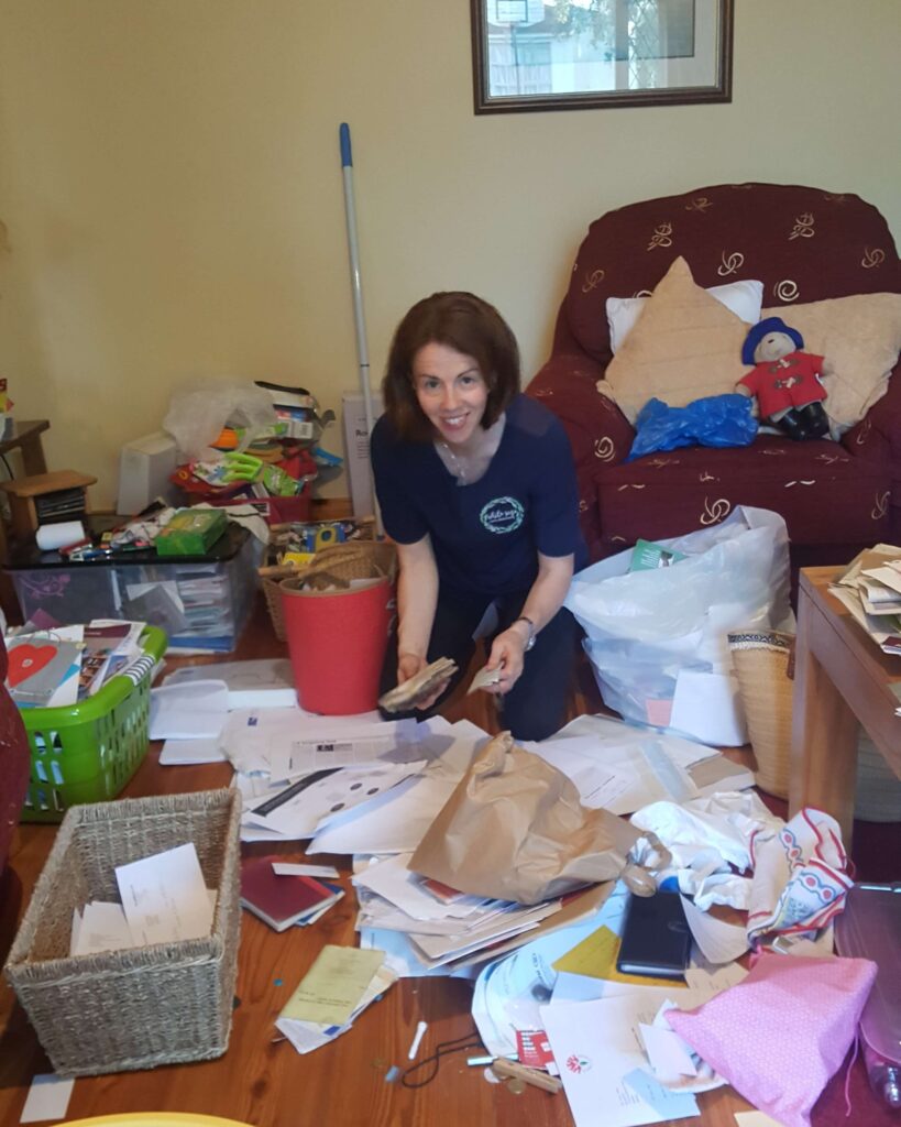 Anne Marie Kingston | White Sage Decluttering on her knees busy decluttering.